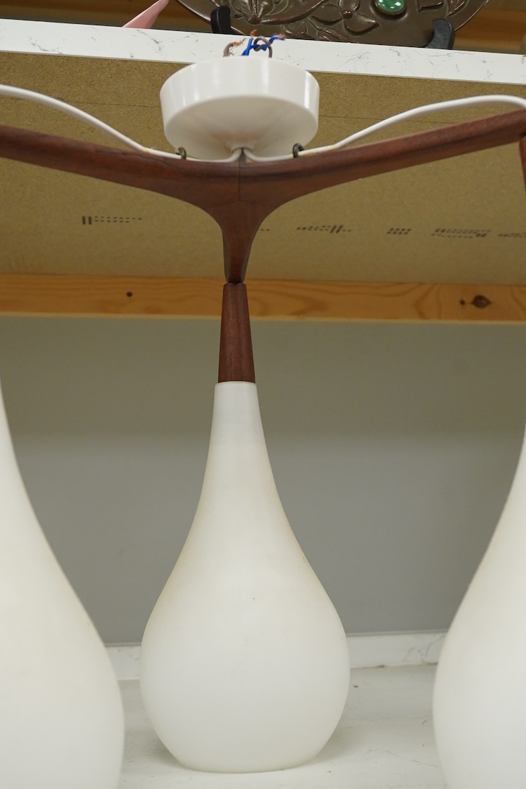 A mid century three light ceiling fitting with opaque glass shades, 38cm high overall